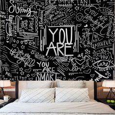 a black and white wall with writing on it that says you are in front of a bed