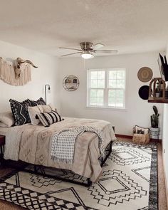 a bed room with a neatly made bed and a rug