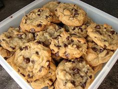 a plastic container filled with chocolate chip cookies