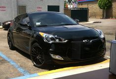 a black car parked in a parking lot