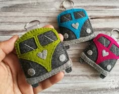 three keychains made out of felt with different colors and designs on each one