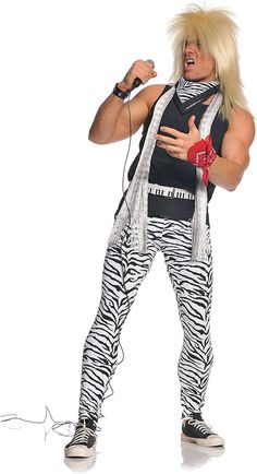 a man dressed in zebra print is singing into a microphone