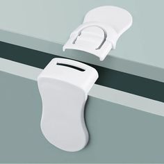 two white plastic handles on a gray wall