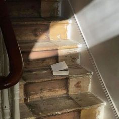 a piece of paper sitting on the bottom of some stairs