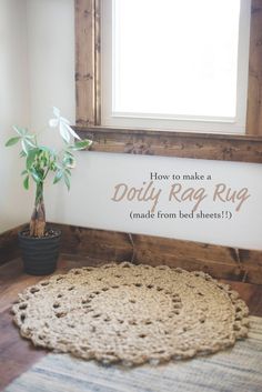 a potted plant sitting on top of a wooden floor next to a sign that says how to make a doily rag rug made from bed sheets?