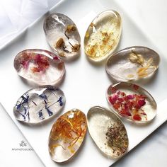 seven different types of rocks on a white plate