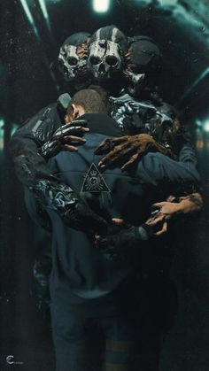 two people in black jackets hugging each other