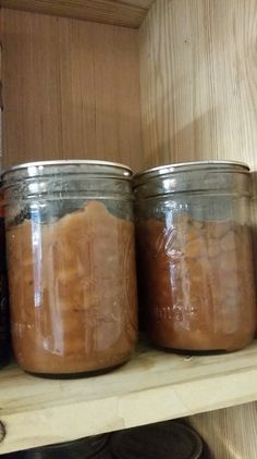 three jars filled with food sitting on top of a shelf