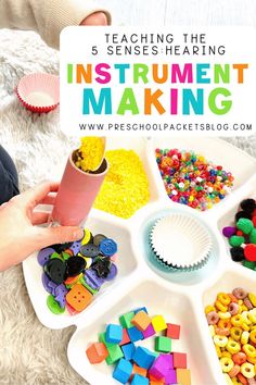 a child's hands holding a paper cup over a tray filled with colorful beads