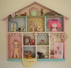 a doll house shelf filled with lots of toys and dolls on it's sides