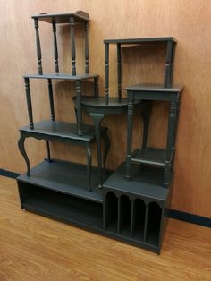 a set of four wooden shelves sitting on top of a hard wood floor