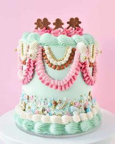 a blue and pink cake with lots of decorations on it