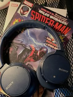 headphones and comic books on a table