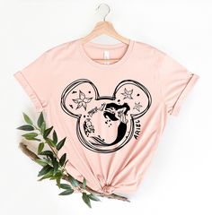 a pink shirt with mickey mouse on it