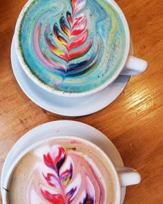 two coffee cups with different colored designs on them