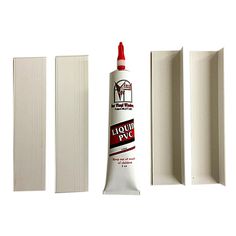 a tube of glue sitting on top of a white wall next to three pieces of paper