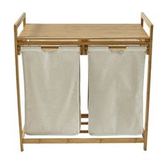 two white laundry hampers sitting next to each other on a wooden rack with canvas curtains