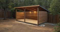 a small wooden shed with lights on the roof and side doors open in front of trees