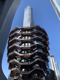 a very tall building with lots of balconies on it's sides in the city