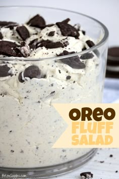 an oreo fluff salad in a glass bowl with chocolate chips and cream on top