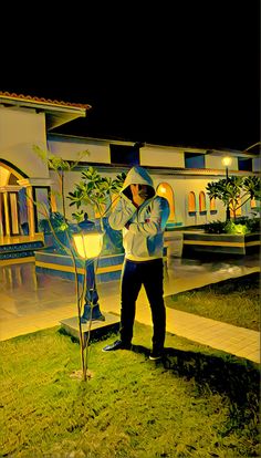 a man standing in front of a house at night