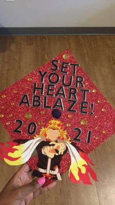 someone holding up a graduation cap that says set your heart ablaze