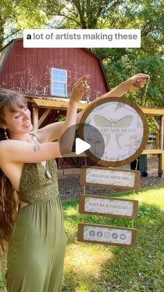 a woman in a green dress standing next to a wooden sign with words on it