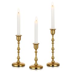 three brass candlesticks on white background