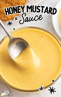 honey mustard sauce in a glass bowl with a spoon on the side and an advertisement above it