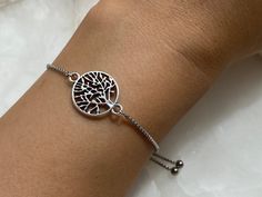 Tree of life bracelet with an adjustable slider and dangly ends Perfect for stacking bracelets Made from stainless steel Antique silver charm Charm size approximately 17 mm x 17 mm Every order comes in our luxury matt frosted recyclable logo pouch, which are also available to purchase separately for any extra pieces you may want to store with style. Gift wrap sets (box & faux leather pouch)  are available at checkout and available to buy separately. Faux Leather Pouch, Tree Of Life Bracelet, Tree Of Life Jewelry, Stacking Bracelets, Wrist Band, Style Gift, Leather Pouch, Bracelet Stack, Family Tree