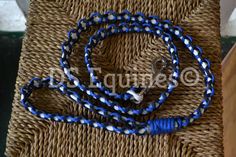 blue and white braided lanyard with metal hooks on woven seat cushioning