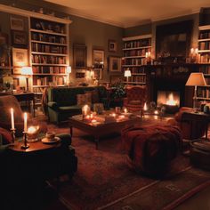 a living room filled with lots of furniture and lit candles in the middle of it