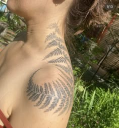 a woman with a fern tattoo on her chest