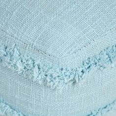 a blue blanket with fringes on it