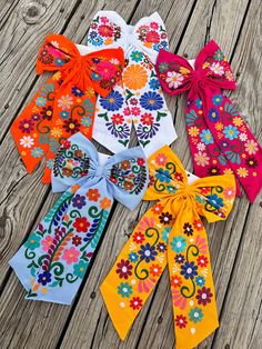 six different colored bows with flowers on them