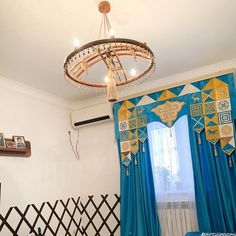 a bed room with a neatly made bed and a chandelier hanging from the ceiling