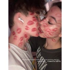 two people with their faces covered in blood and the man is kissing the woman's face