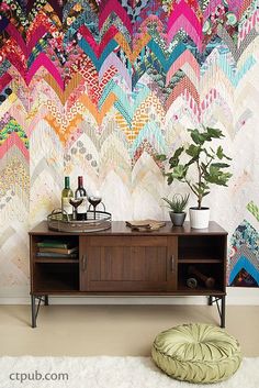 a living room with a colorful wallpaper and rug