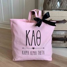 Kappa Alpha Theta sorority letters and name custom printed on pink canvas tote bag with black bow Kappa Alpha Theta Canvas, Phi Mu Canvas, Pink Canvas Tote Bag, Little Gifts Sorority, Reuseable Bag, College Tote Bag, Bid Day Gifts, Pink Tote Bag, Big Little Gifts