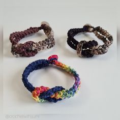 three bracelets with different colors and designs on white surface, one is multicolored