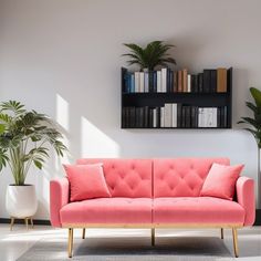 a pink couch sitting in front of a book shelf