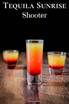 tequila sunrise shooter in three shot glasses on a wooden table with text overlay that reads tequila sunrise shooter