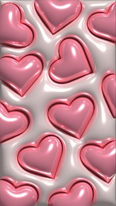 many pink hearts are arranged in the shape of heart shapes on a white background with light reflections