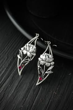 ITEM DESCRIPTION: Size H 80 x W 20 mm (3 x 3/4 inches) with closure. Wire earrings are very lightweight and comfortable for your ears. Weight - 5 g of each other. I made these elegant earrings of sterling silver and rhodolite and red garnet. But you can order them with another stone or write me in convo if you don't see your favorite stone in variations. They are made in the shape of a leaf peony with lush large peony flowers in the middle. These silver earrings are intricate and layered hand-fa Handmade Elegant Flower Pendant Earrings, Elegant Silver Flower Pendant Earrings, Peony Jewelry, Flower Stone, Metal Clay Jewelry, Peony Flowers, Garnet Jewelry, Wedding Jewelry Earrings, Handcrafted Earrings