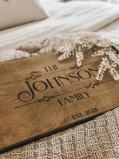 a personalized wooden sign on top of a bed