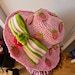 a pink hat sitting on top of a wooden table