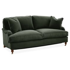 a green couch with two pillows on it