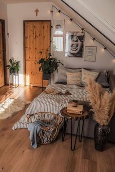 a bed sitting in the middle of a living room next to a fire place and wooden floors