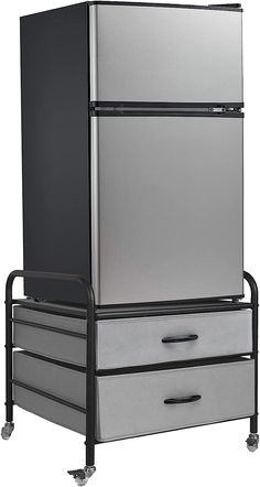 two drawers are stacked on top of each other in front of a refrigerator and freezer