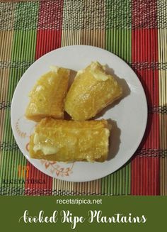 three pieces of food on a plate sitting on a place mat with a colorful table cloth